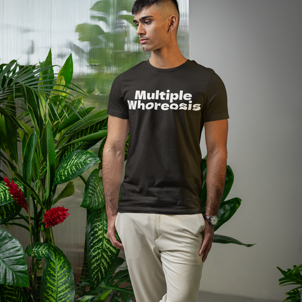 Man wearing a black t-shirt with 'Multiple Whoreosis' text in an indoor setting with plants.