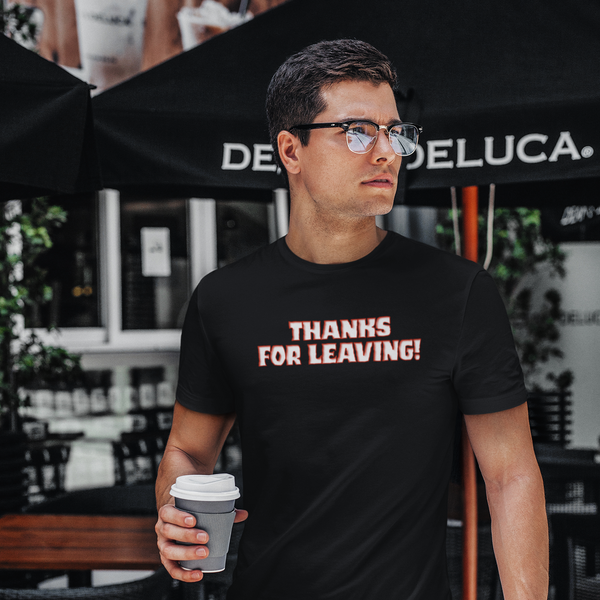 Man wearing a black t-shirt with code-style text, holding a coffee cup outdoors.