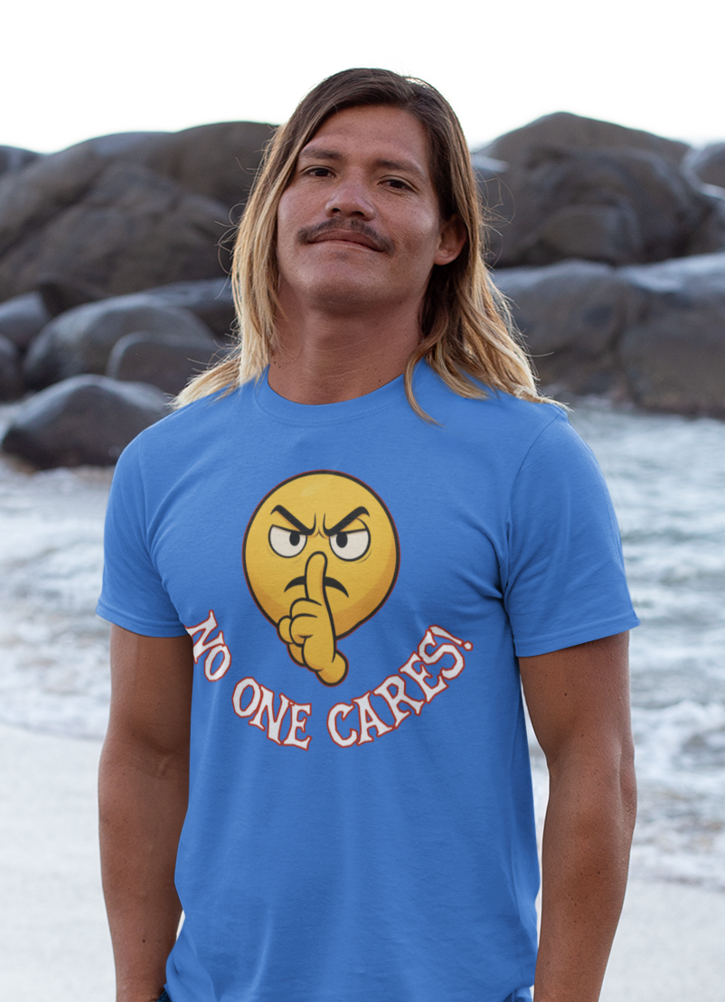 Man wearing a blue t-shirt with a graphic design on a beach